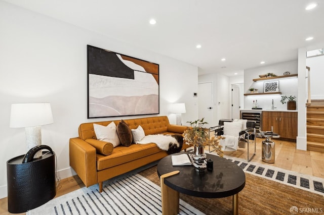 living room featuring wine cooler and light wood-type flooring