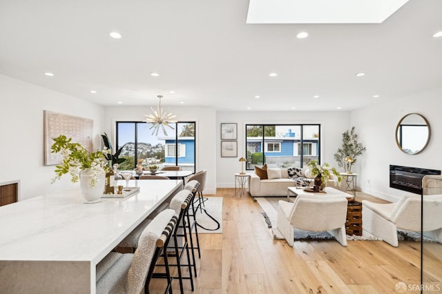 interior space featuring a notable chandelier and light wood-type flooring