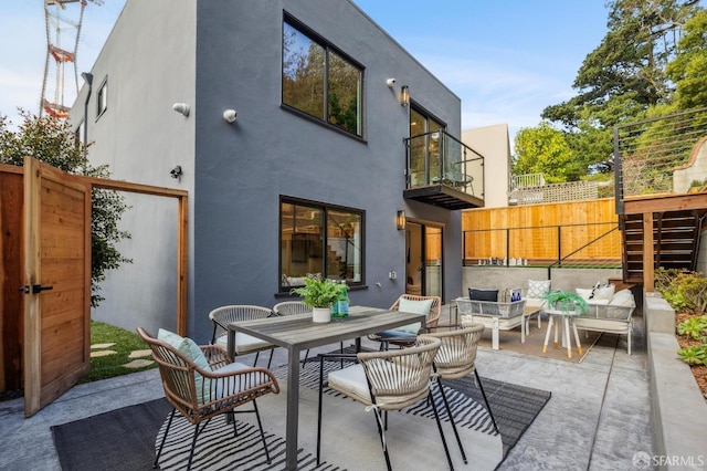 rear view of property with outdoor lounge area and a patio area