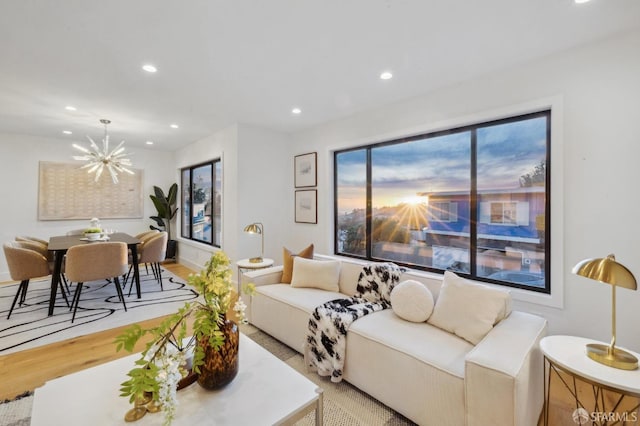 living room with light hardwood / wood-style flooring and a chandelier