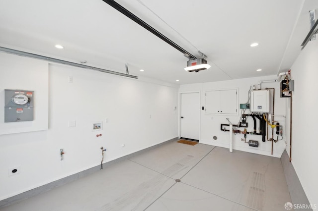 garage featuring a garage door opener and tankless water heater