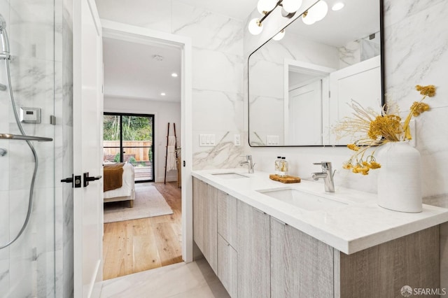 bathroom with vanity, hardwood / wood-style flooring, and walk in shower