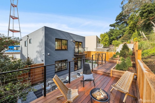 wooden deck with a fire pit