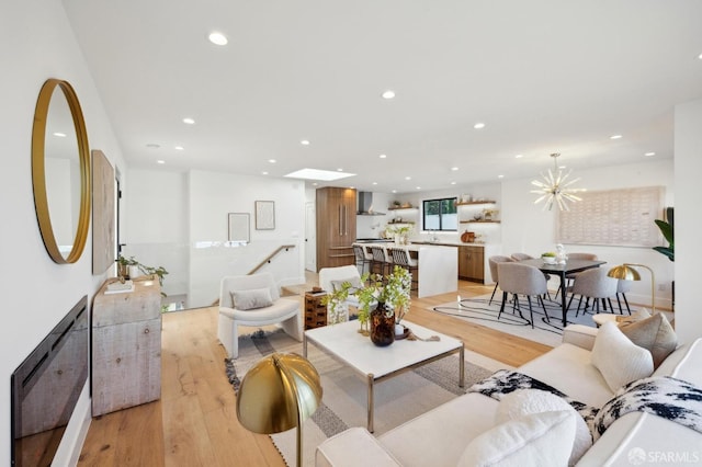 living room with a chandelier and light wood-type flooring