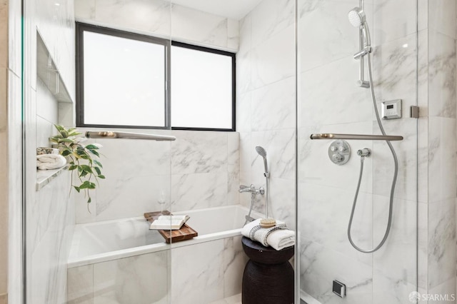 bathroom featuring shower with separate bathtub