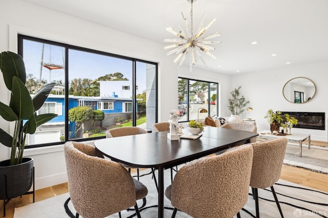 dining area featuring light hardwood / wood-style floors and a notable chandelier