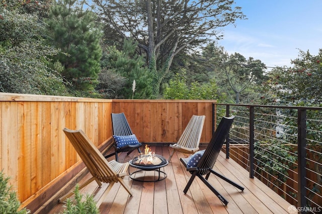 wooden deck with an outdoor fire pit