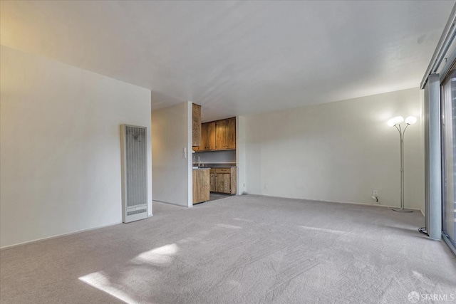 unfurnished living room with light colored carpet