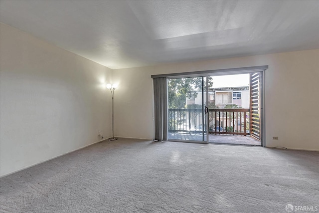 carpeted spare room with a textured ceiling