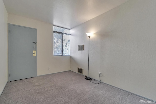 unfurnished room featuring light colored carpet