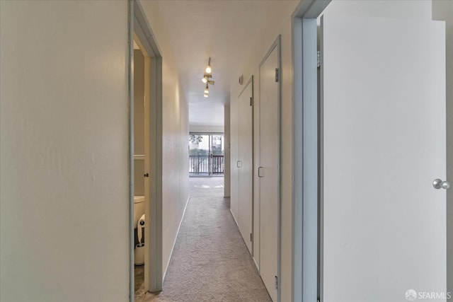 hallway with light colored carpet