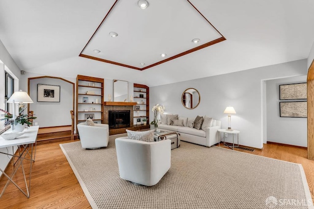 35 Ardilla Rd, Orinda, CA 94563 - living room featuring lofted ceiling, light wood-type flooring, a fireplace, built in shelves, and recessed lighting