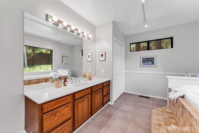 35 Ardilla Rd, Orinda, CA 94563 - bathroom featuring tiled bath, vanity, and tile patterned floors