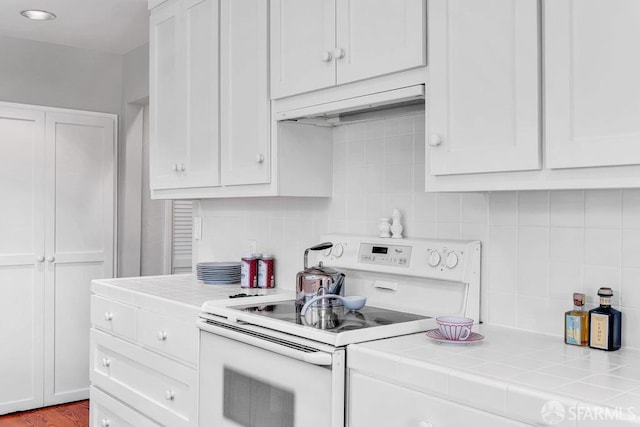 35 Ardilla Rd, Orinda, CA 94563 - kitchen with electric stove, tile countertops, exhaust hood, and white cabinets
