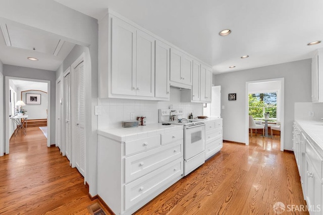 35 Ardilla Rd, Orinda, CA 94563 - kitchen with white electric range, white cabinets, tasteful backsplash, light wood-style floors, and recessed lighting