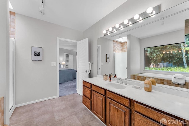 35 Ardilla Rd, Orinda, CA 94563 - bathroom featuring connected bathroom, track lighting, vanity, tile patterned flooring, and a tub to relax in