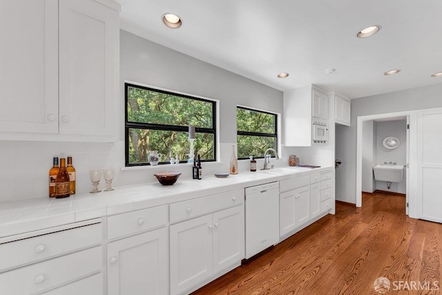 35 Ardilla Rd, Orinda, CA 94563 - kitchen featuring dishwasher, white cabinets, backsplash, recessed lighting, and wood finished floors
