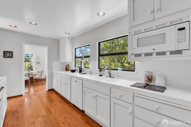 35 Ardilla Rd, Orinda, CA 94563 - kitchen with white appliances, tile countertops, recessed lighting, tasteful backsplash, and white cabinetry