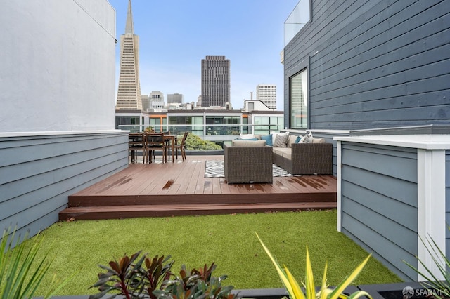 wooden terrace featuring an outdoor hangout area and a yard