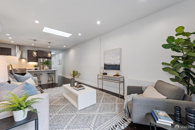 living room with wood-type flooring and a skylight