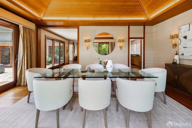 dining space featuring a tray ceiling and wooden ceiling
