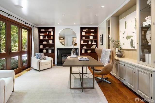 home office with recessed lighting, french doors, and wood finished floors