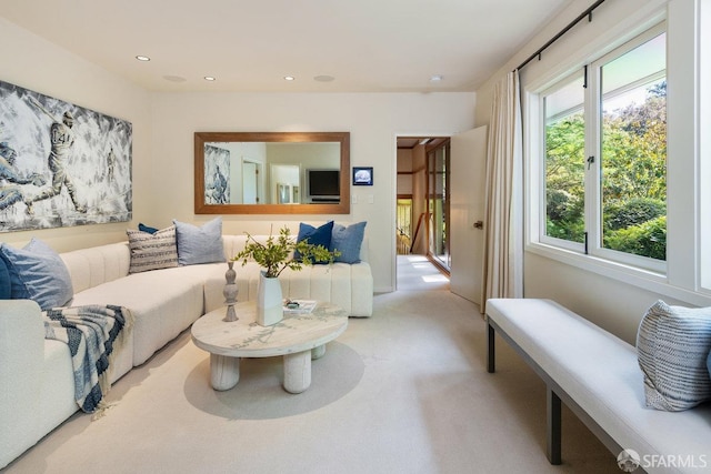 living room with recessed lighting and light colored carpet