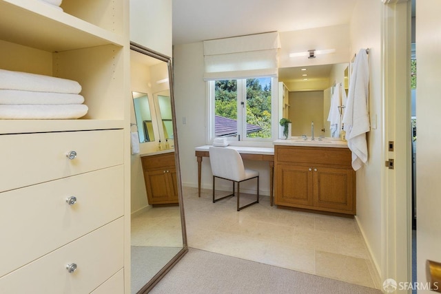 bathroom featuring baseboards and vanity
