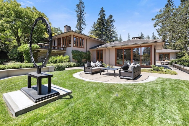 back of property with a yard, an outdoor living space, a patio area, and a chimney