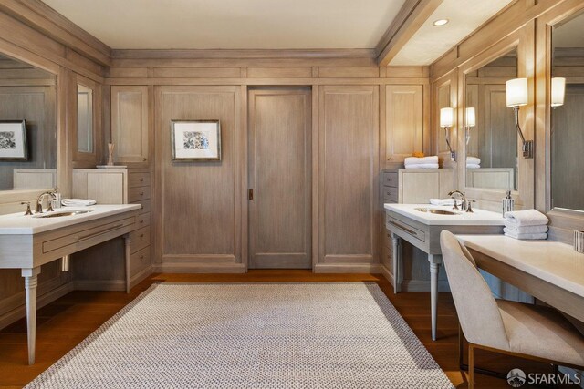 bathroom with wood finished floors, vanity, and wooden walls