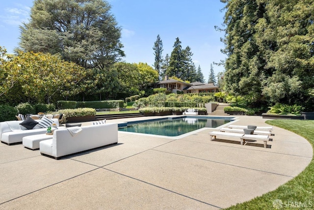 pool with a patio and outdoor lounge area
