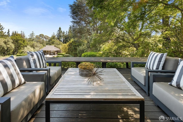 wooden terrace featuring an outdoor living space