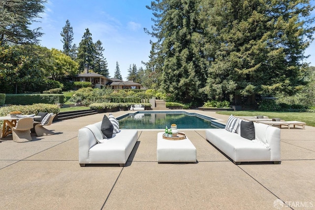 pool featuring a patio area and an outdoor living space
