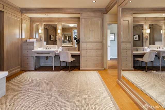 bathroom with recessed lighting, vanity, crown molding, and wood finished floors