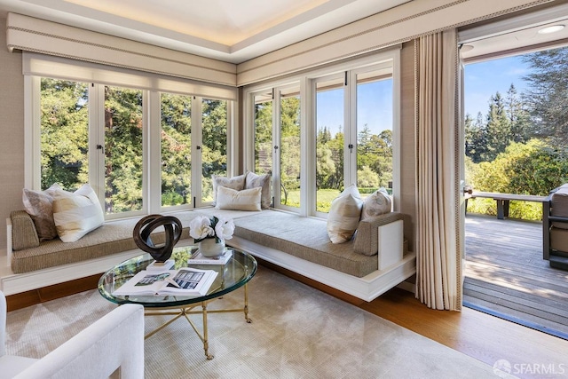 sunroom featuring a wealth of natural light and wood finished floors