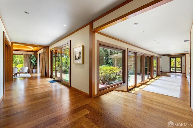 entryway featuring french doors, baseboards, and wood finished floors
