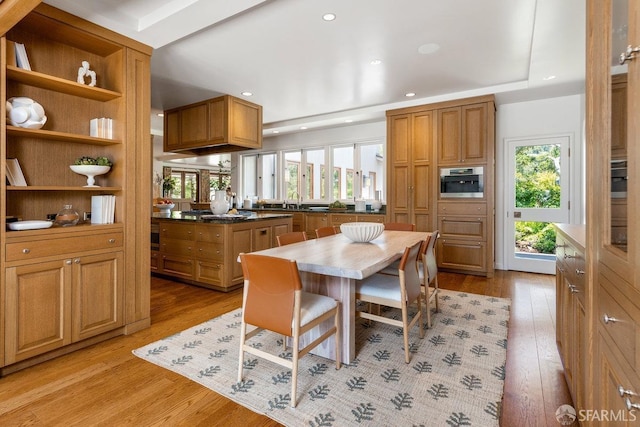 dining room featuring recessed lighting, light wood-type flooring, and a healthy amount of sunlight