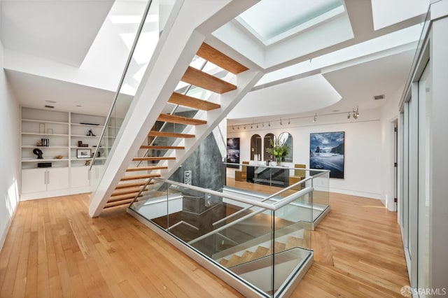 stairway with hardwood / wood-style floors