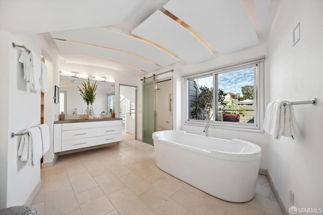 bathroom featuring vanity, independent shower and bath, and tile patterned flooring