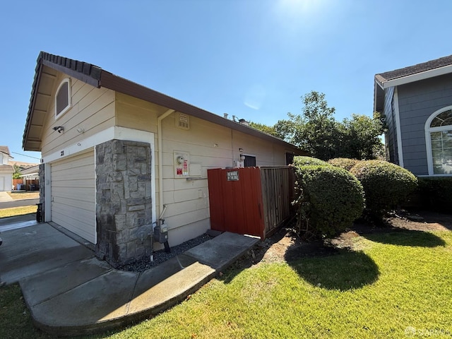 328 Snow Flake Way, Pittsburg, CA 94565 - view of property exterior featuring a garage, a yard, and stone siding