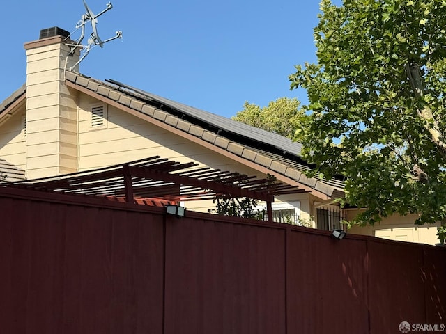 328 Snow Flake Way, Pittsburg, CA 94565 - view of side of property with solar panels, a chimney, and a pergola