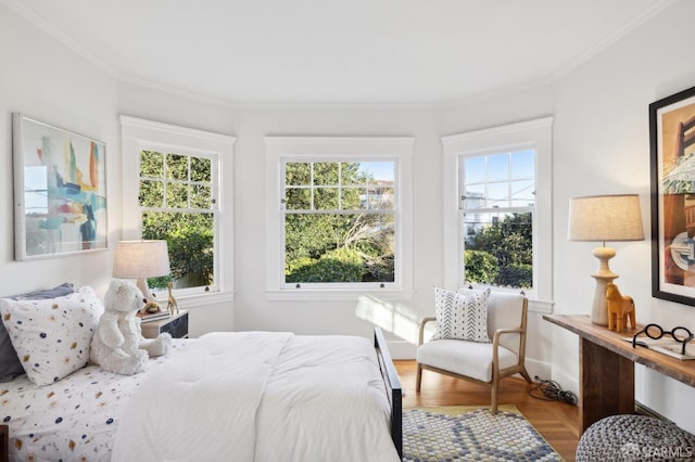 bedroom with wood-type flooring, multiple windows, and ornamental molding