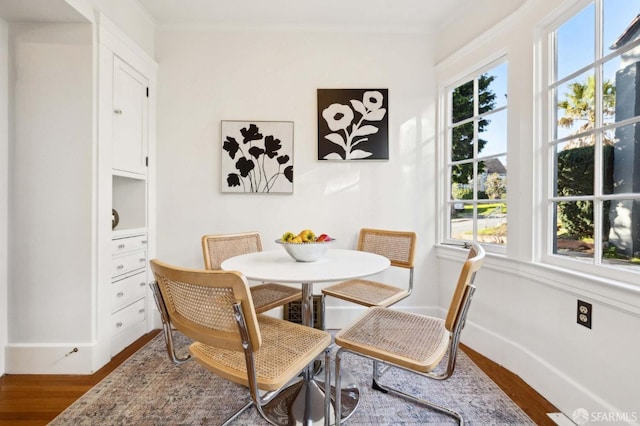 dining room featuring ornamental molding and hardwood / wood-style floors