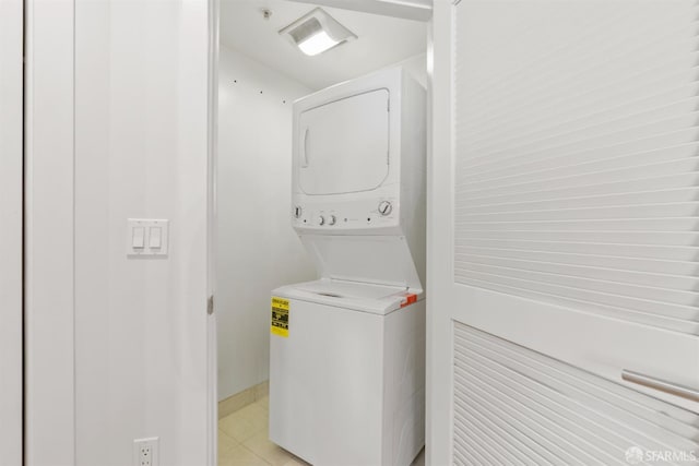 washroom featuring stacked washer / dryer