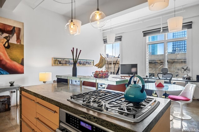 kitchen featuring stainless steel appliances, a kitchen island, and pendant lighting