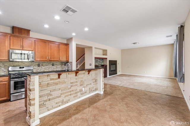 3642 Mallard Way, Antioch, CA 94509 - kitchen with light carpet, dark countertops, visible vents, appliances with stainless steel finishes, and light tile patterned floors