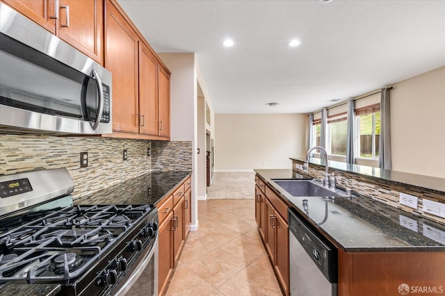 3642 Mallard Way, Antioch, CA 94509 - kitchen featuring brown cabinetry, a sink, dark stone counters, tasteful backsplash, and appliances with stainless steel finishes