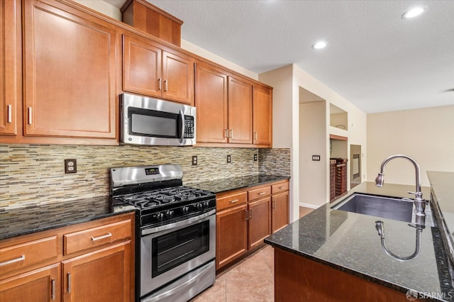 3642 Mallard Way, Antioch, CA 94509 - kitchen featuring a sink, dark stone counters, backsplash, appliances with stainless steel finishes, and light tile patterned floors