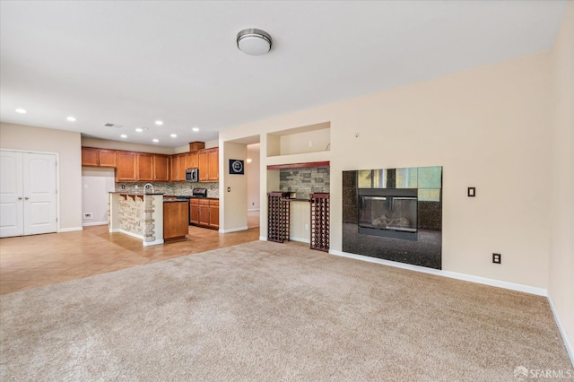 3642 Mallard Way, Antioch, CA 94509 - unfurnished living room featuring a glass covered fireplace, light tile patterned floors, light carpet, baseboards, and recessed lighting