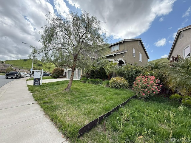 3642 Mallard Way, Antioch, CA 94509 - view of property exterior featuring stucco siding, a yard, concrete driveway, and a garage